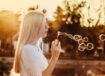 woman-blowing-bubbles-during-sunset-alkJl-mokOY