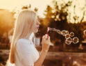 woman-blowing-bubbles-during-sunset-alkJl-mokOY