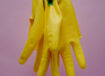 Yellow cleaning gloves hanging from a string.karolina-kolodziejczak