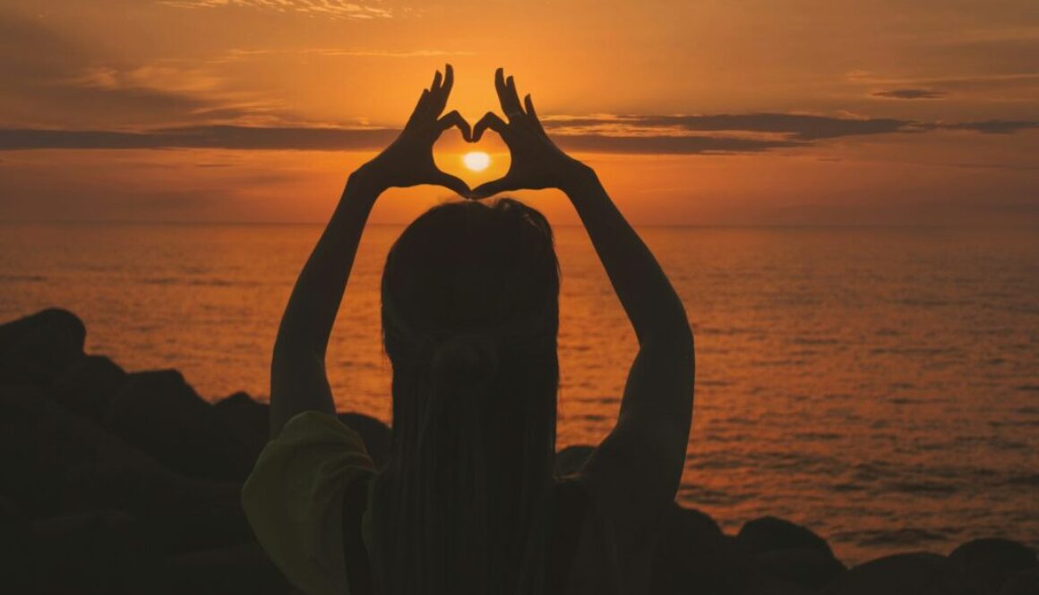 silhouette-of-woman-doing-heart-sign-during-sunset-gv3VWXwKrrA