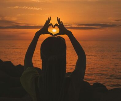 silhouette-of-woman-doing-heart-sign-during-sunset-gv3VWXwKrrA