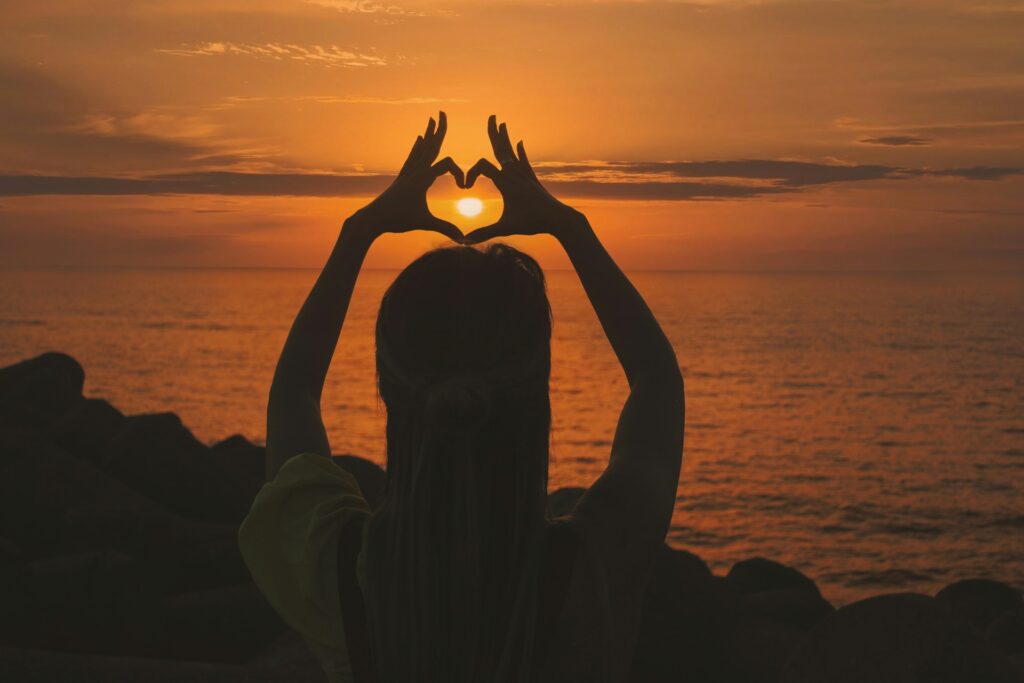 silhouette-of-woman-doing-heart-sign-during-sunset-gv3VWXwKrrA