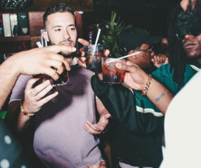 three-people-holding-glass-bottles-while-talking-_qADvinJi20