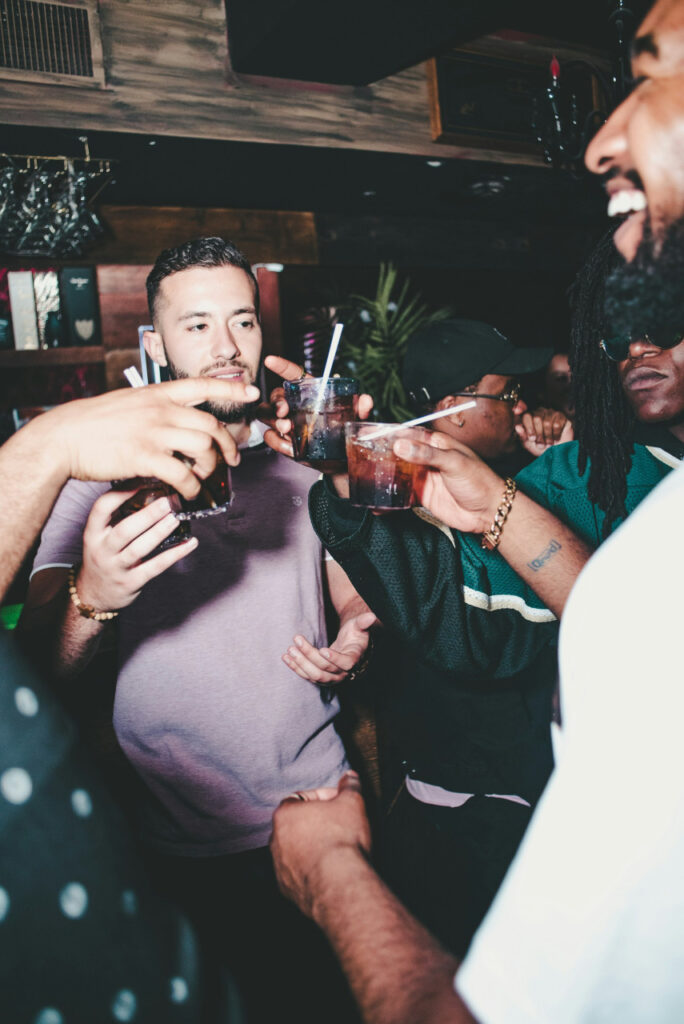 three-people-holding-glass-bottles-while-talking-_qADvinJi20