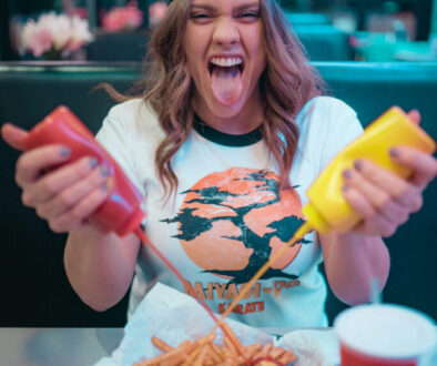 woman-in-white-and-red-mickey-mouse-crew-neck-t-shirt-holding-french-fries-s2MjR3xoJkE