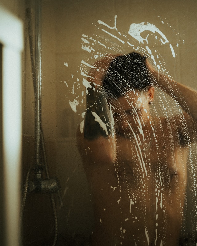 Adult taking a shower.