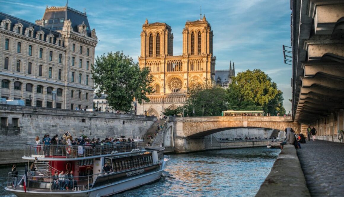 a-boat-on-a-river-with-buildings-on-either-side-of-it