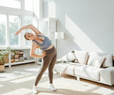 a-woman-in-activewear-stretching-her-arms-at-home-8846094/