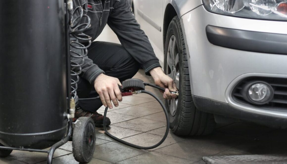 man-in-black-jacket-and-black-pants-sitting-near-silver-vehicle-3807386/