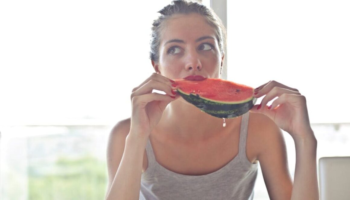 woman-in-gray-tank-top-holding-watermelon-768454/