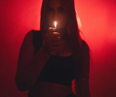 mysterious-woman-holding-lighter-in-dark-room-30197148/